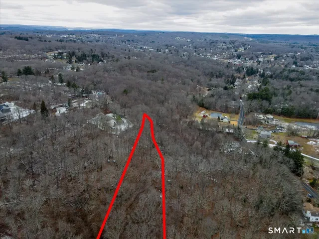an aerial view of a houses with a yard