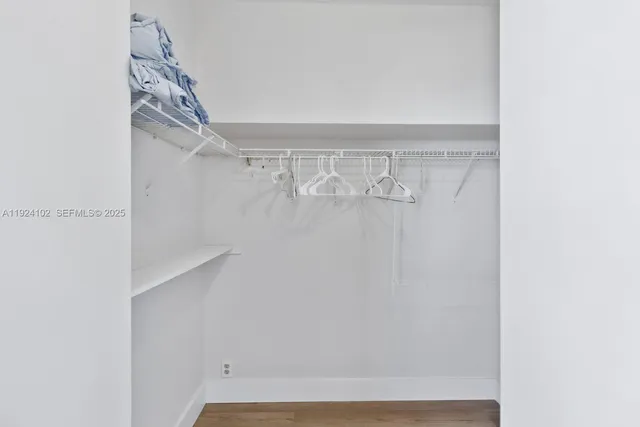 a view of walk in closet with empty racks