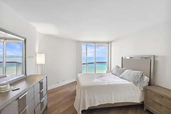 a bedroom with a bed and a large window