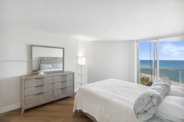 a bedroom with a bed and a mirror