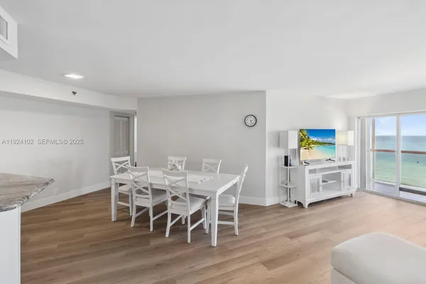 a dining room with furniture and wooden floor