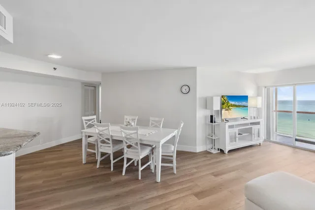 a dining room with furniture and wooden floor