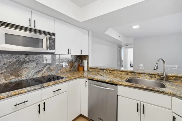 a kitchen with sink cabinets and stainless steel appliances