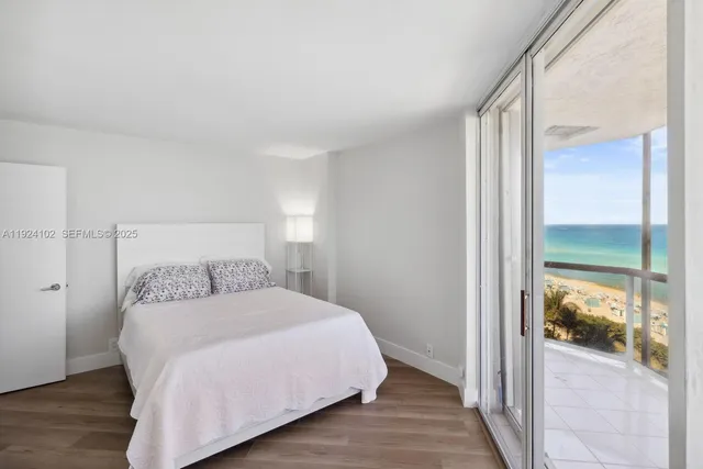 a bedroom with a bed and glass door