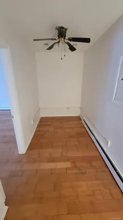 a view of a room with wooden floor