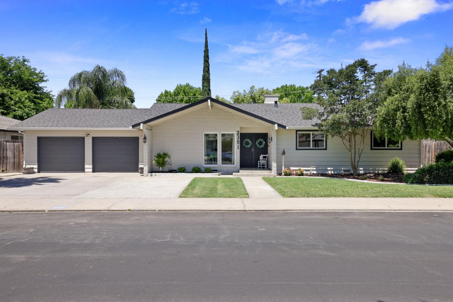2301 Surrey Avenue Modesto, CA 95355 - Photo 1 of 1 a view of front a house with a yard and garage