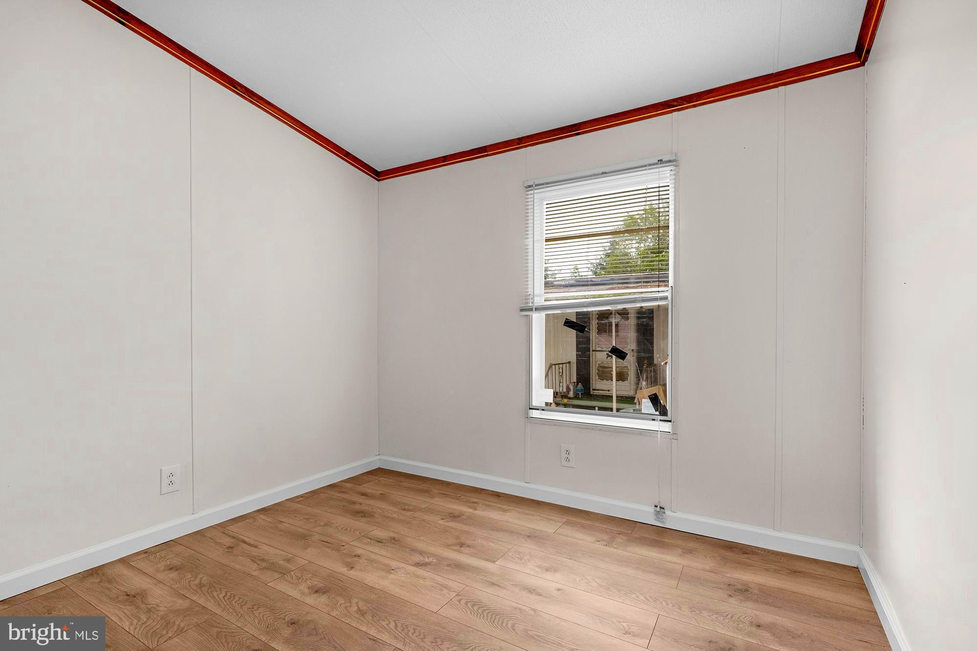 11540 Philadelphia Road, Unit 5A White Marsh, MD 21162 - Photo 12 of 23 an empty room with wooden floor and windows