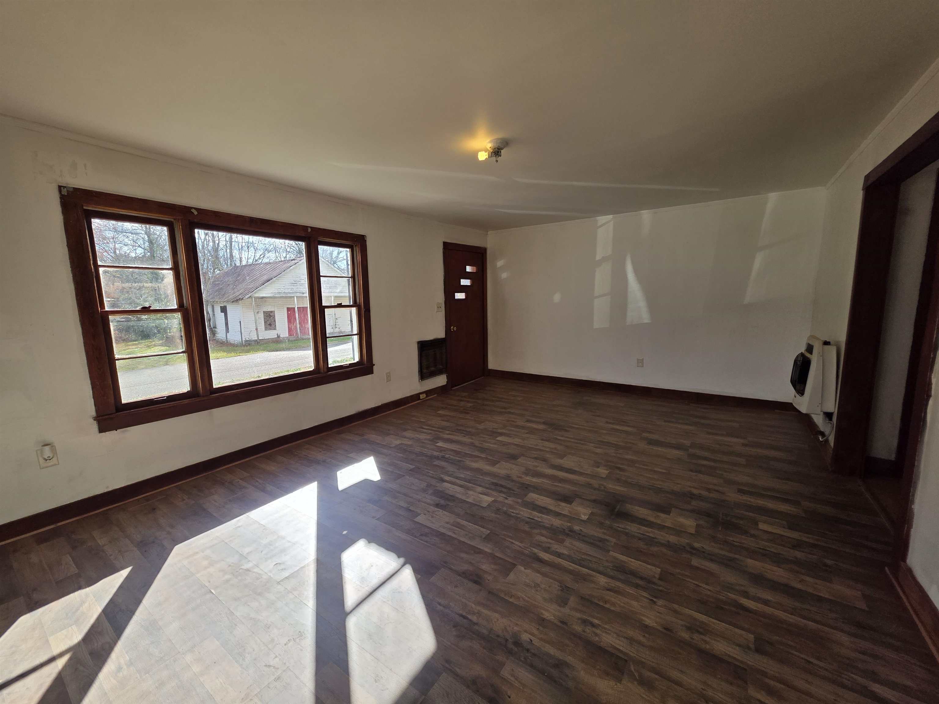 95 Sugar Maple Avenue Savannah, TN 38372 - Photo 2 of 11 wooden floor in an empty room with a window
