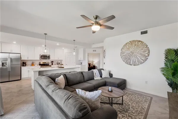 a living room with furniture and kitchen view