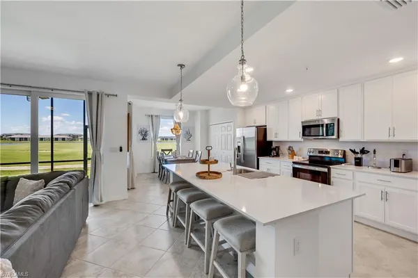 a kitchen with a stove a refrigerator and a dining table