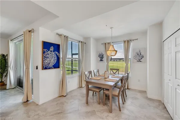a dining room with furniture a rug and a chandelier