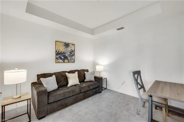 a living room with furniture a couch and a dining table