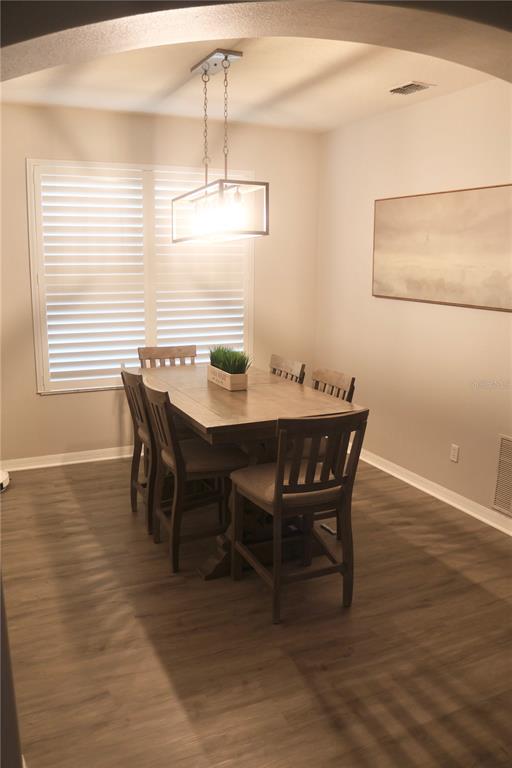 3850 Beacon Ridge Way Clermont, FL 34711 - Photo 38 of 41 a view of a dining room with furniture window and wooden floor