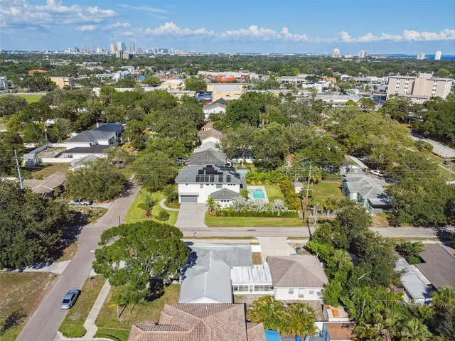 an aerial view of residential houses with outdoor space and river