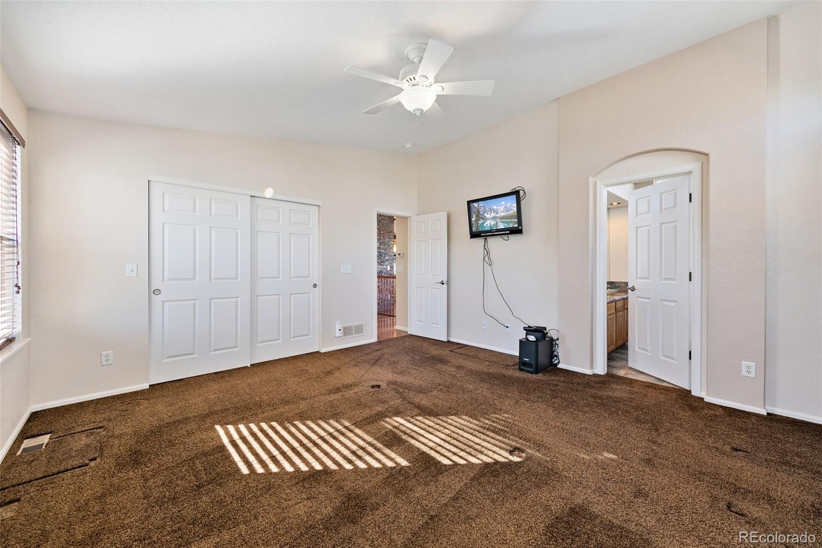 10072 Williams Way Thornton, CO 80229 - Photo 16 of 24 a view of a livingroom with a ceiling fan and window