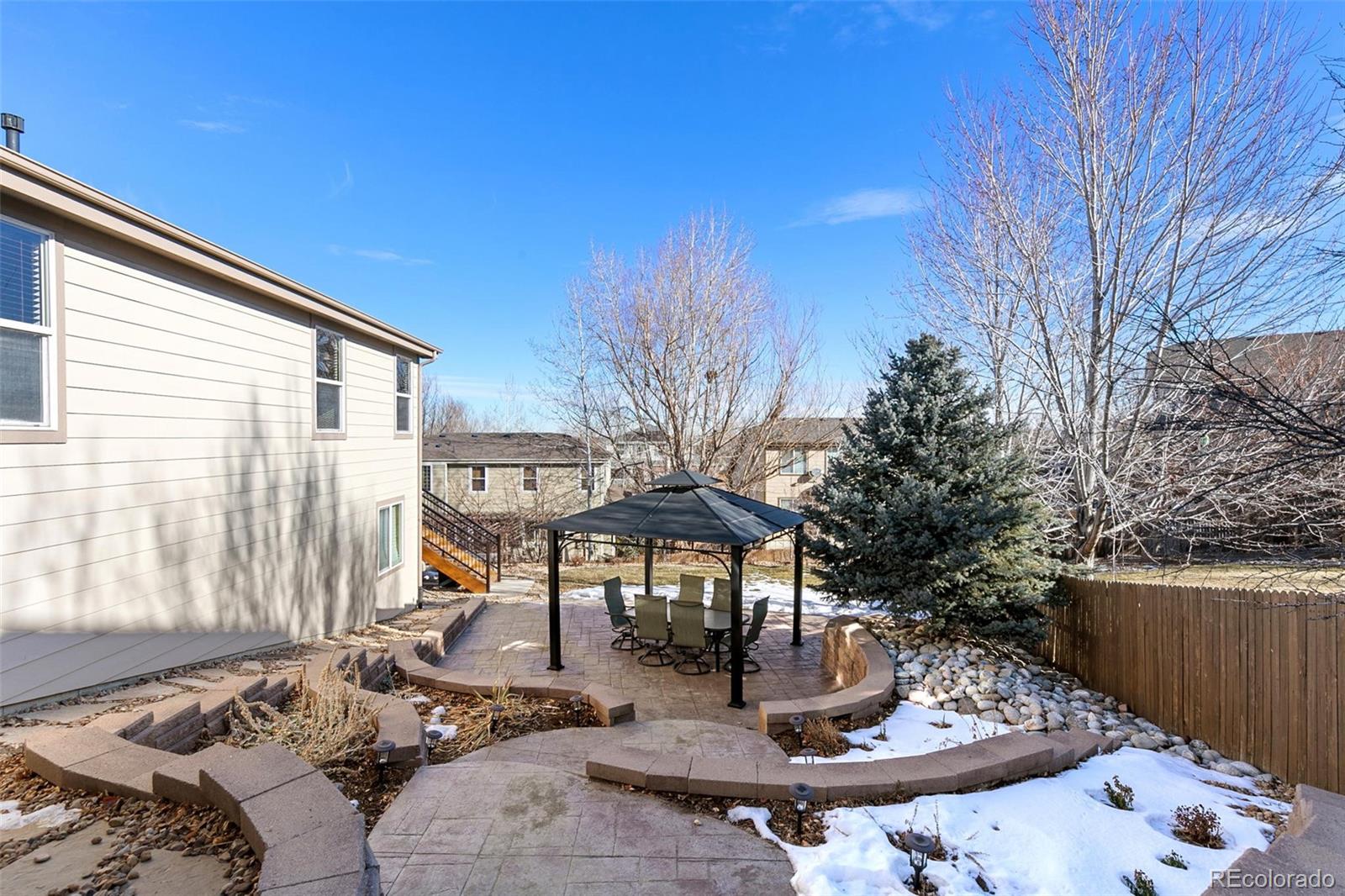10072 Williams Way Thornton, CO 80229 - Photo 20 of 24 a view of a patio with table and chairs and potted plants