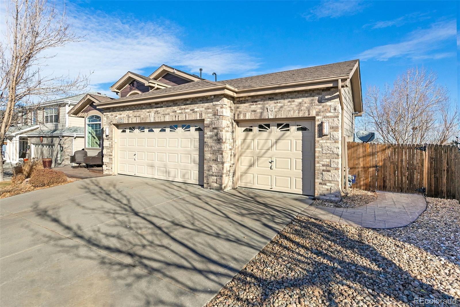 10072 Williams Way Thornton, CO 80229 - Photo 2 of 24 a front view of a house with a yard