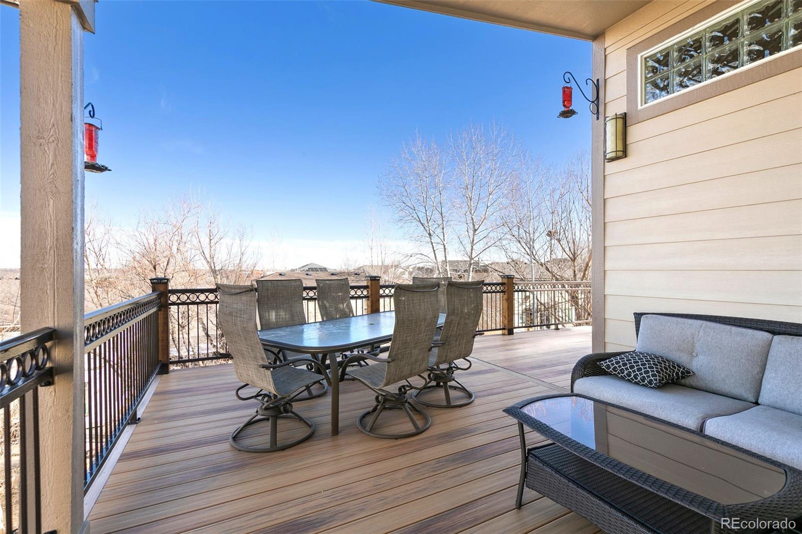 10072 Williams Way Thornton, CO 80229 - Photo 24 of 24 a balcony with wooden floor table and chairs