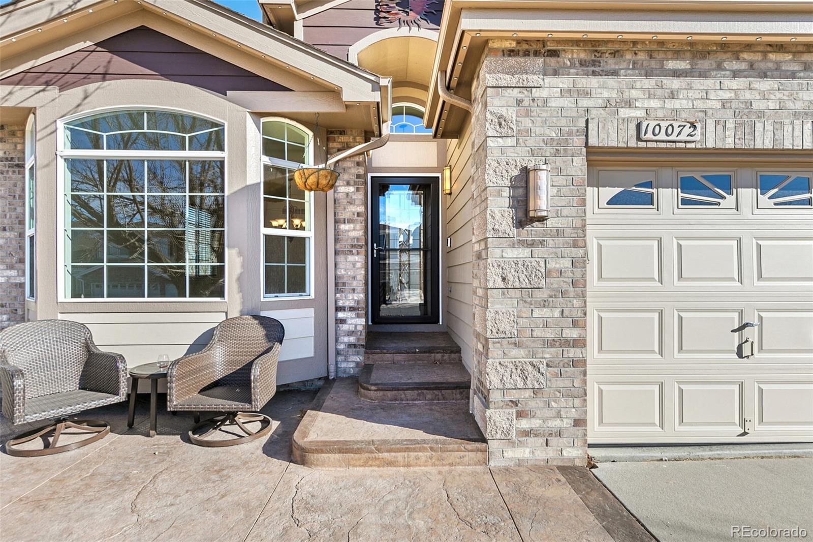 10072 Williams Way Thornton, CO 80229 - Photo 3 of 24 a front view of a building with a glass door