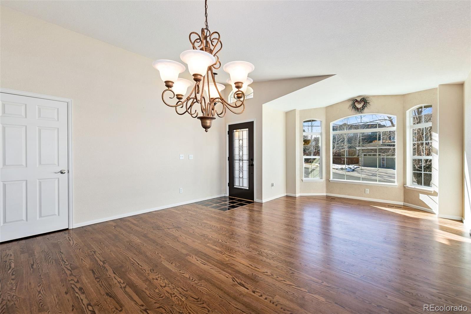 10072 Williams Way Thornton, CO 80229 - Photo 5 of 24 a view of an empty room with wooden floor and a window