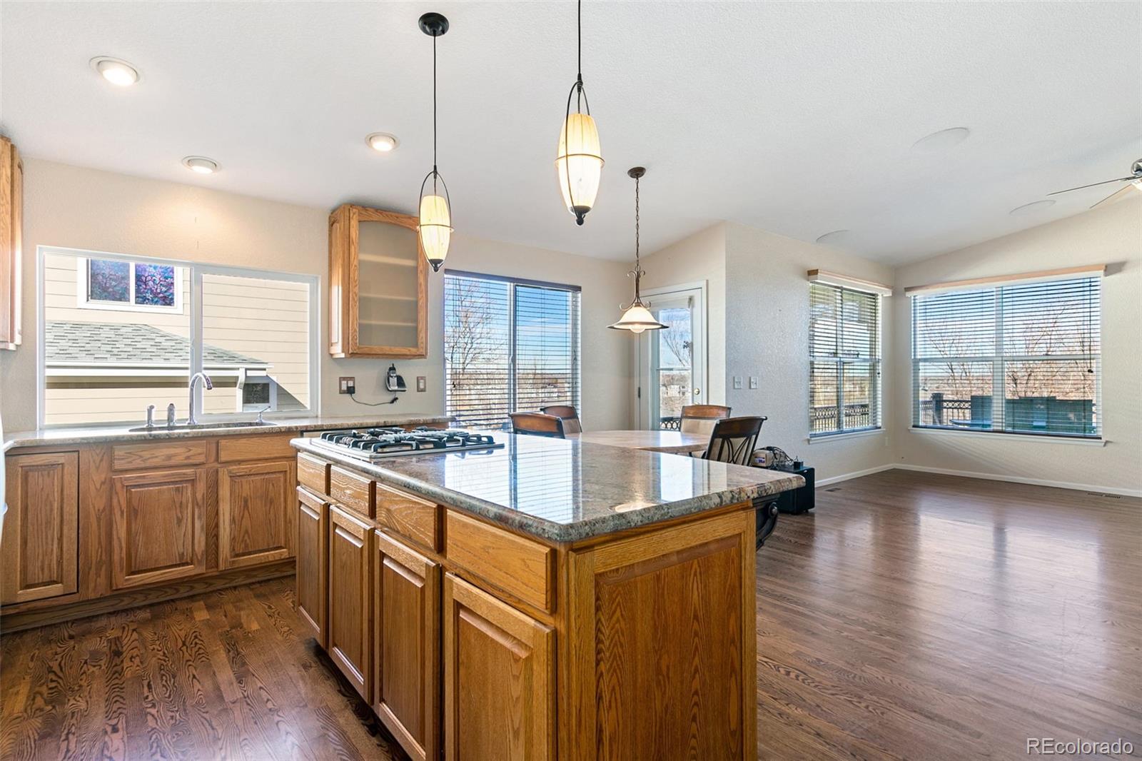 10072 Williams Way Thornton, CO 80229 - Photo 7 of 24 a kitchen with stainless steel appliances granite countertop a sink a stove and a wooden floors