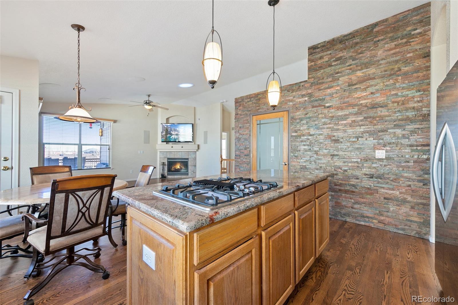 10072 Williams Way Thornton, CO 80229 - Photo 8 of 24 a kitchen with stainless steel appliances granite countertop a stove a sink dishwasher and a wooden cabinets