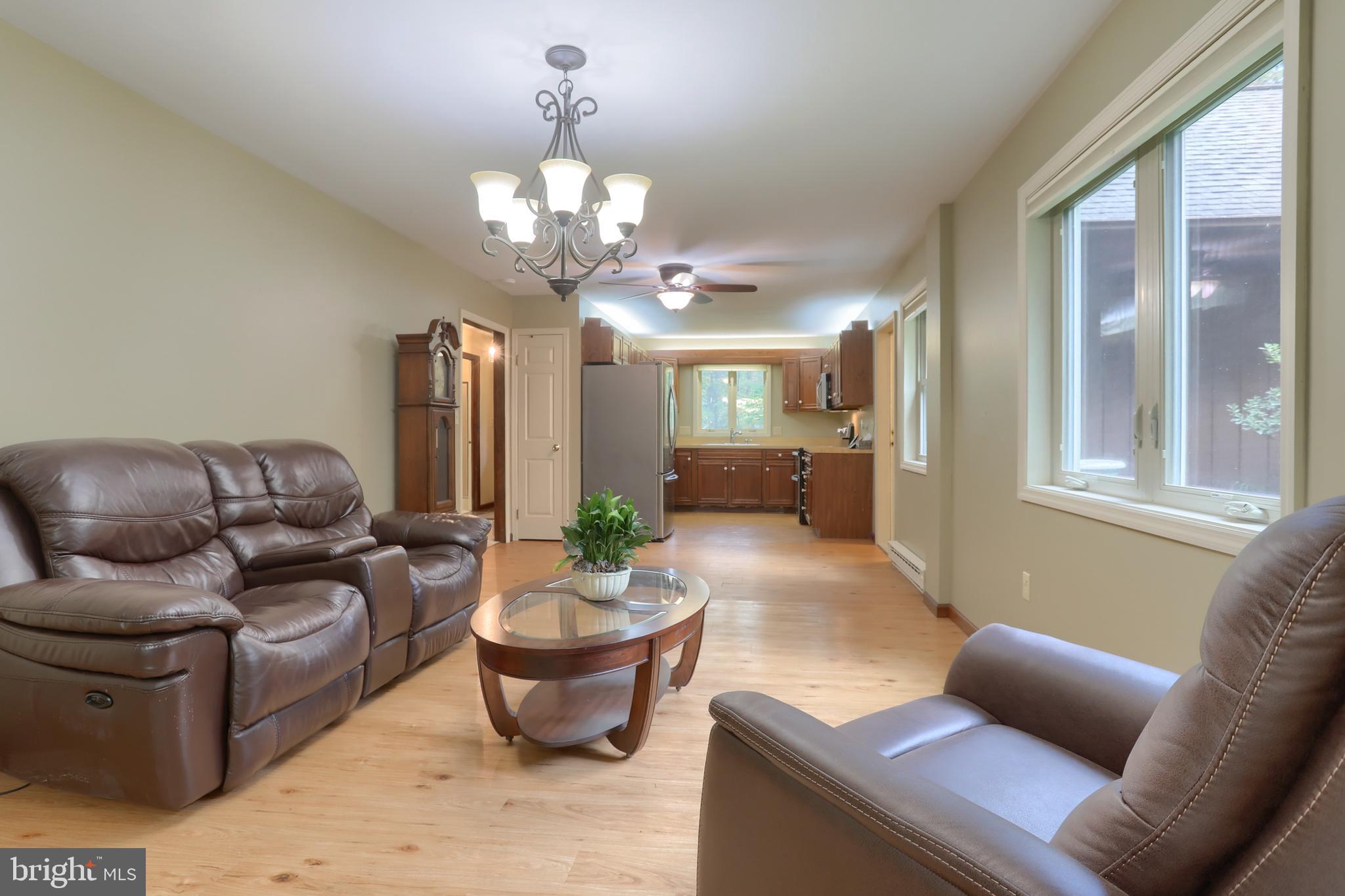 903 Tulip Tree Drive Lebanon, PA 17042 - Photo 15 of 54 a living room with furniture potted plant and a chandelier