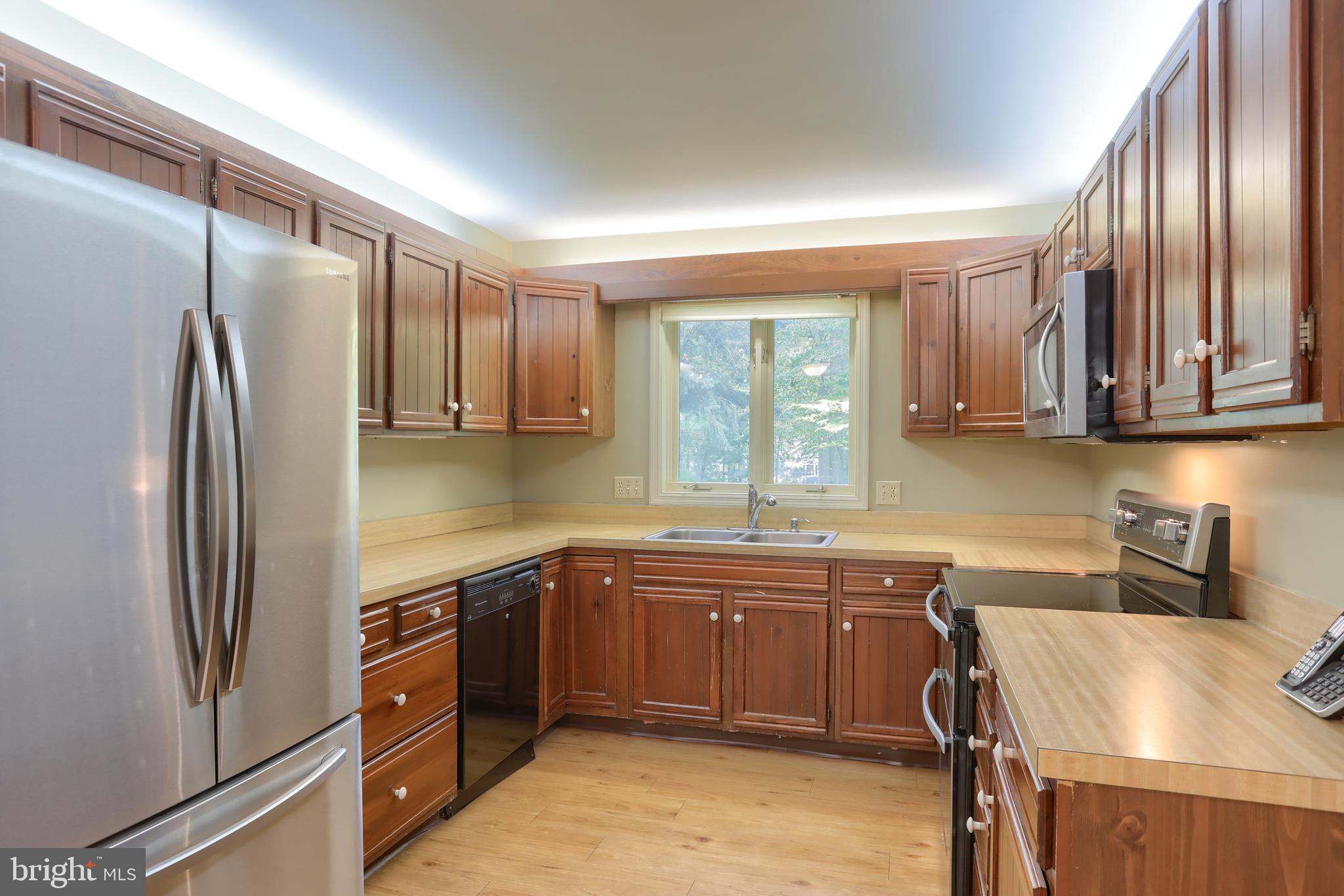 903 Tulip Tree Drive Lebanon, PA 17042 - Photo 20 of 54 a kitchen with stainless steel appliances granite countertop a sink stove and refrigerator
