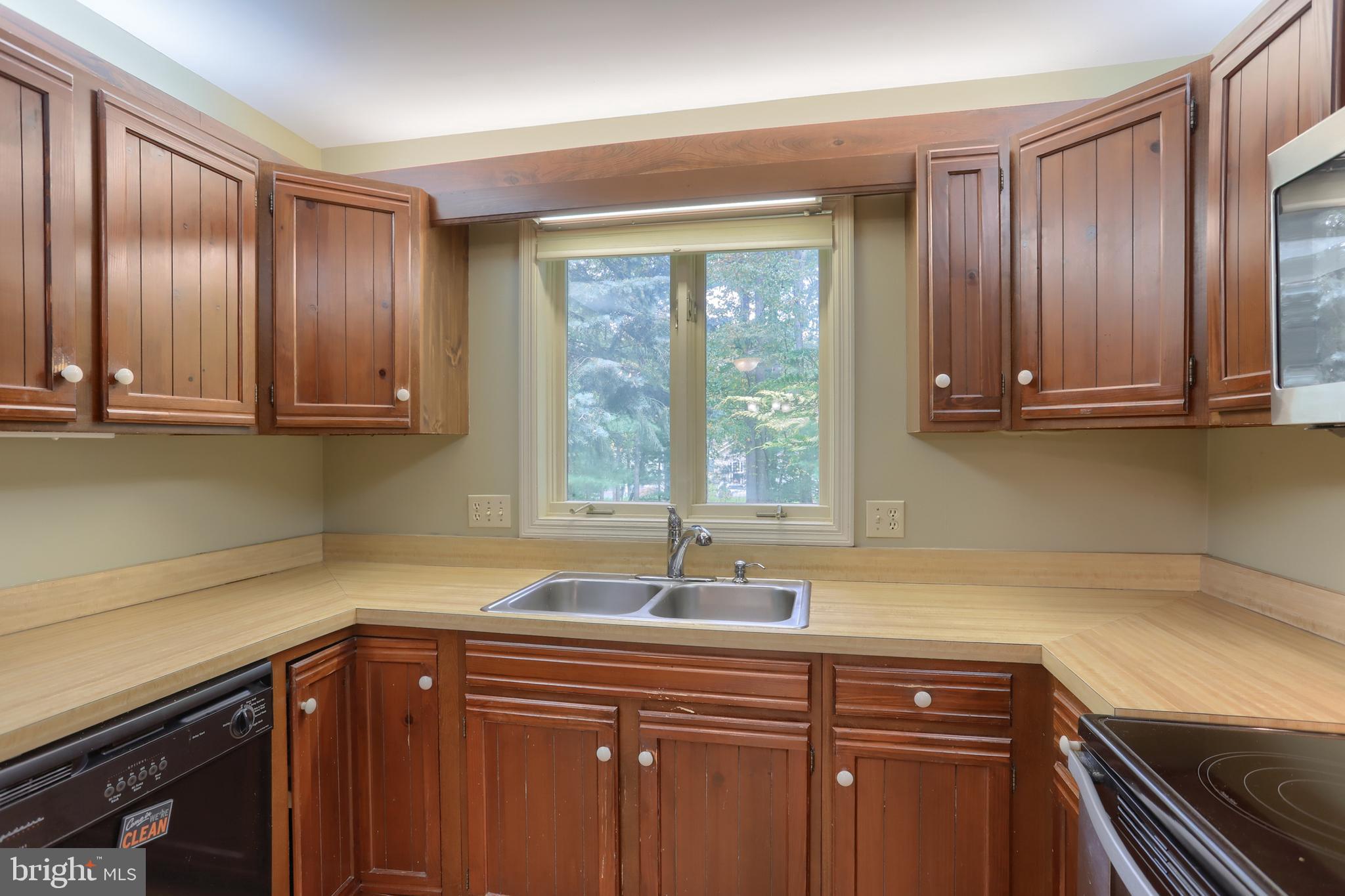 903 Tulip Tree Drive Lebanon, PA 17042 - Photo 21 of 54 a kitchen with stainless steel appliances granite countertop a sink and a wooden cabinets