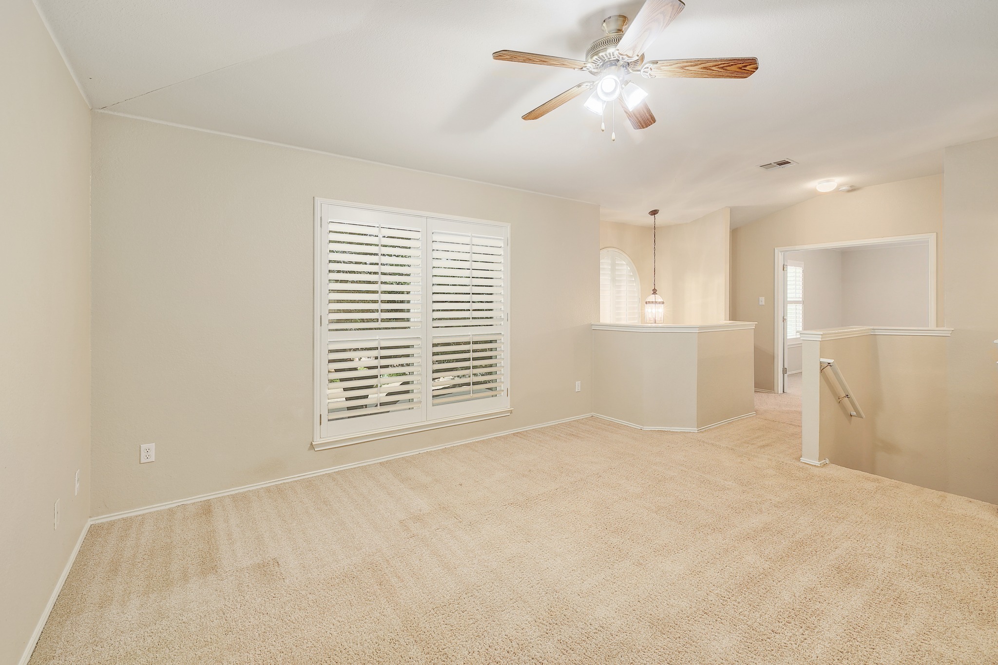 4615 Tello Path Austin, TX 78749 - Photo 16 of 31 A spacious carpeted upper-level landing features plantation shutters and opens directly to the staircase.