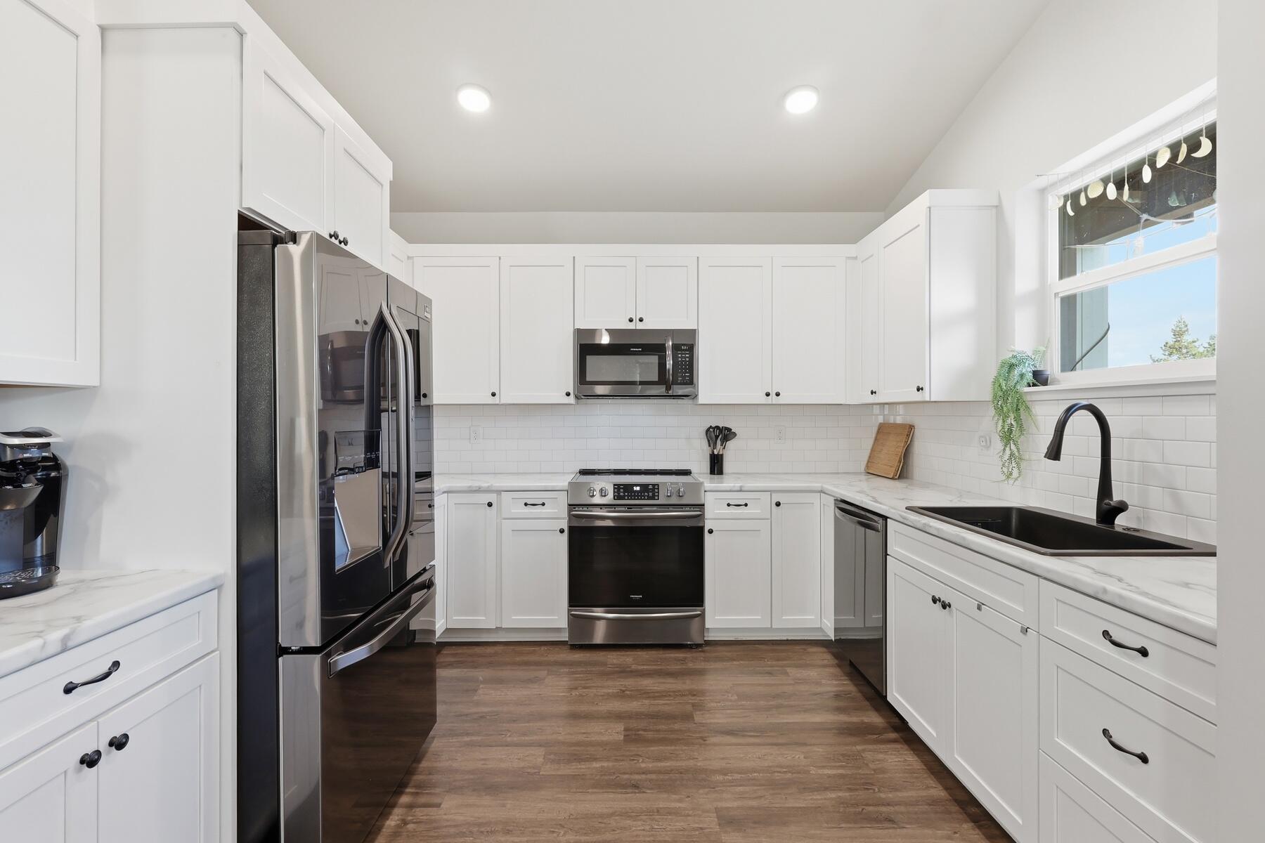 16455 Bassett Road La Pine, OR 97739 - Photo 10 of 44 a kitchen with stainless steel appliances granite countertop a refrigerator sink and stove
