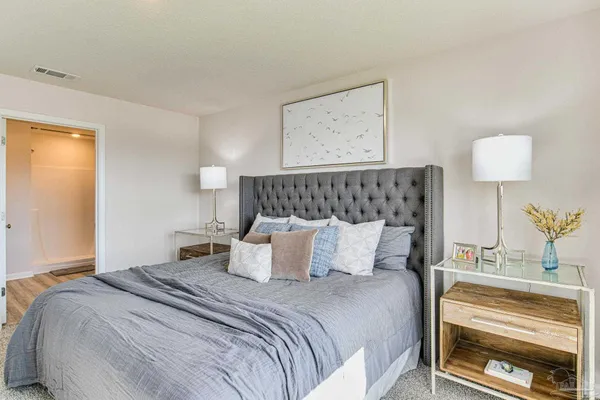 a bedroom with a bed and a dresser