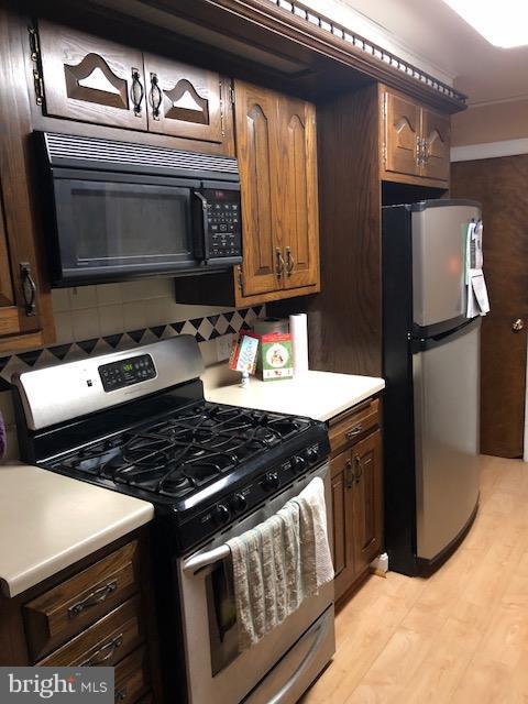 7802 Kavanagh Road Baltimore, MD 21222 - Photo 3 of 9 a kitchen with a stove and a microwave