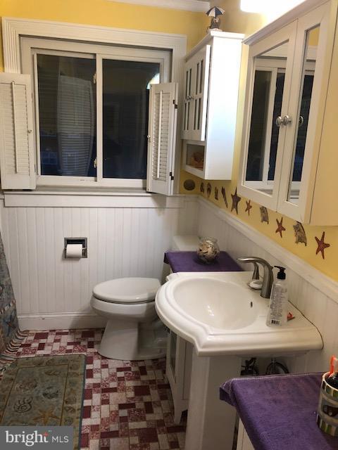 7802 Kavanagh Road Baltimore, MD 21222 - Photo 6 of 9 a bathroom with a sink and a toilet