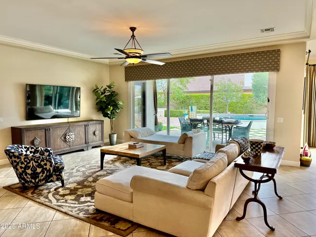 a living room with furniture large window and flat screen tv