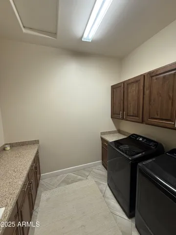 a kitchen with granite countertop cabinets and stove top oven