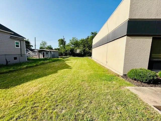 a view of a backyard with plants and a lake view