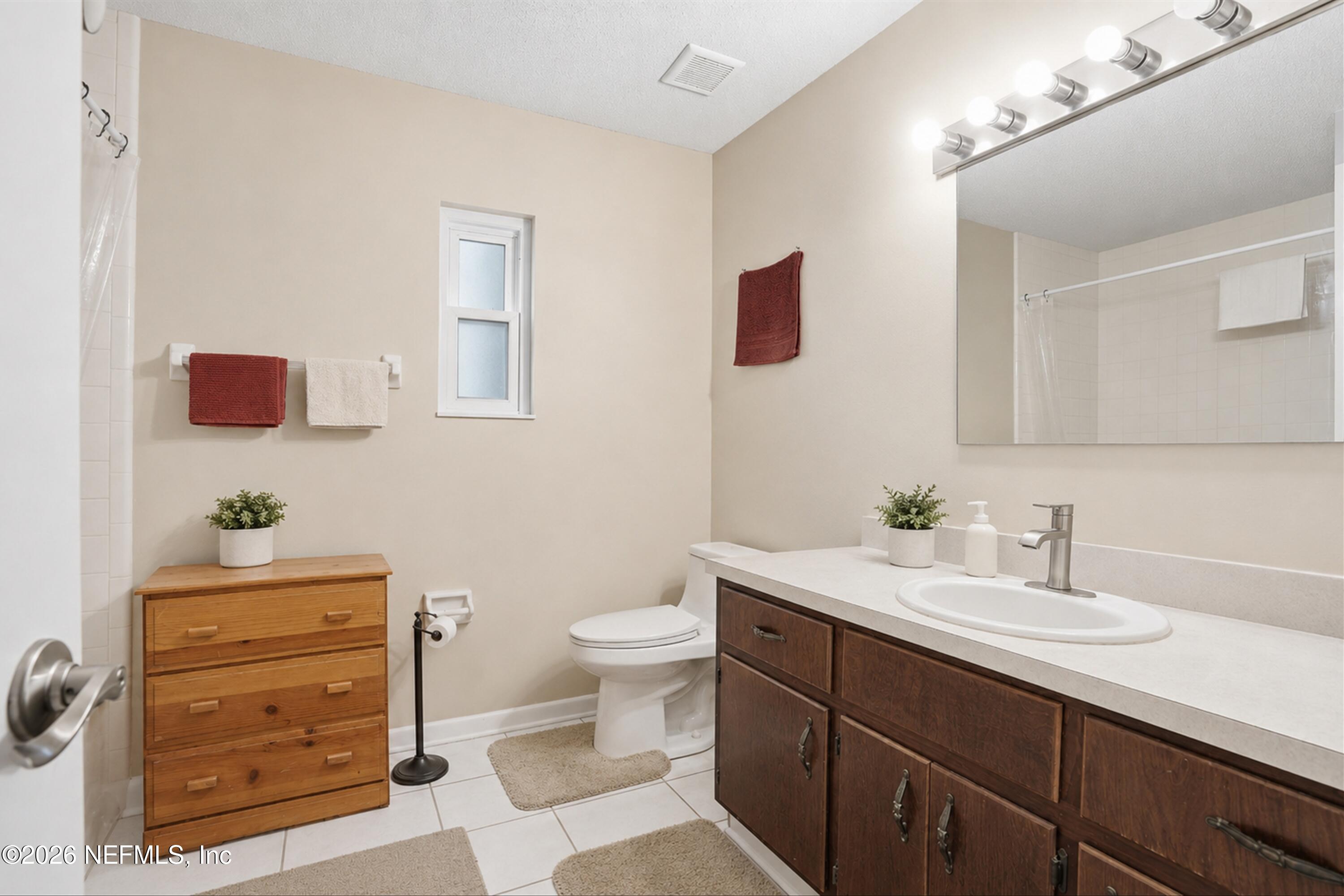 124 Hopkins Street Neptune Beach, FL 32266 - Photo 26 of 44 a bathroom with a sink toilet and mirror