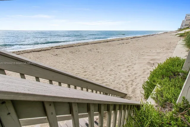 a roof deck with a table and chairs
