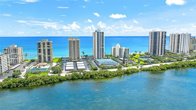 a front view of a city with lots of residential buildings and lake view