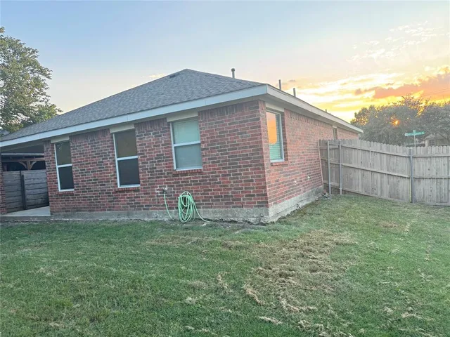 a brick house with a yard