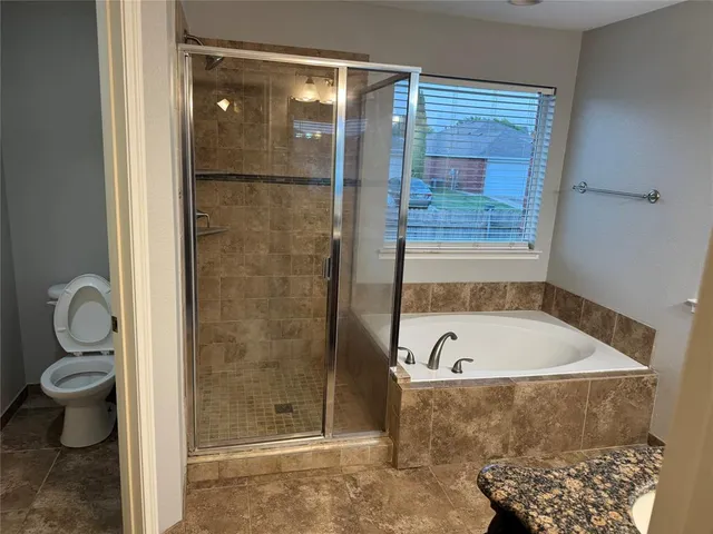 a bathroom with a tub and a shower