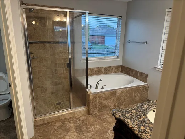 a bathroom with a tub and shower
