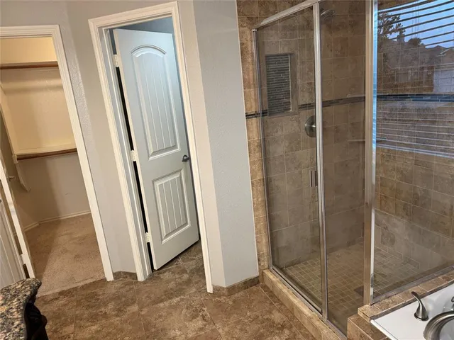a bathroom with a shower and a sink
