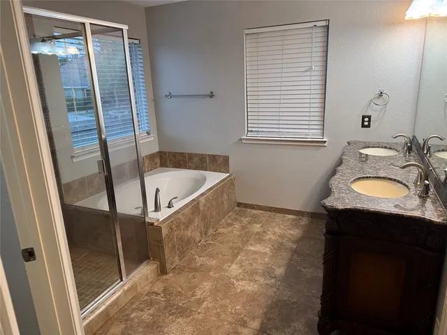 a bathroom with a granite countertop sink a toilet and shower