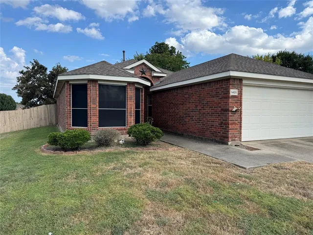 a kitchen with granite countertop white cabinets and stainless steel appliances