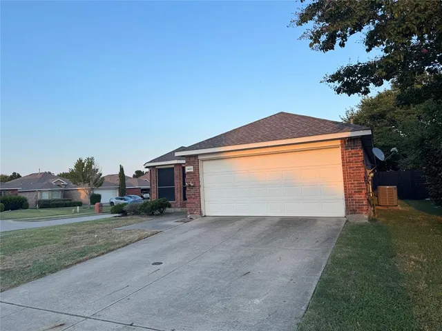 a view of a house with a yard and garage