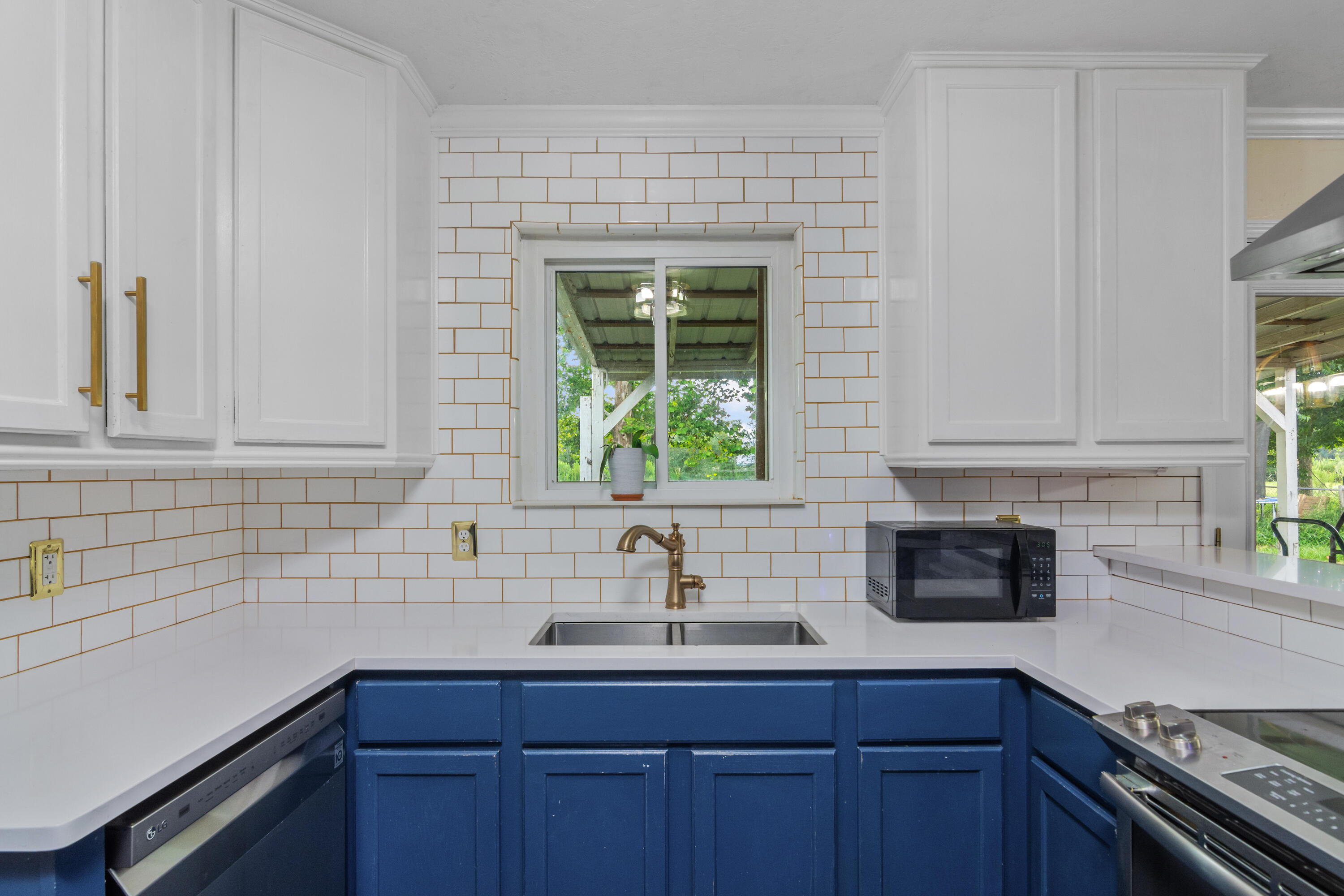6072 Jack Stokes Road Baker, FL 32531 - Photo 1 of 29 a kitchen with stainless steel appliances a sink a stove and window