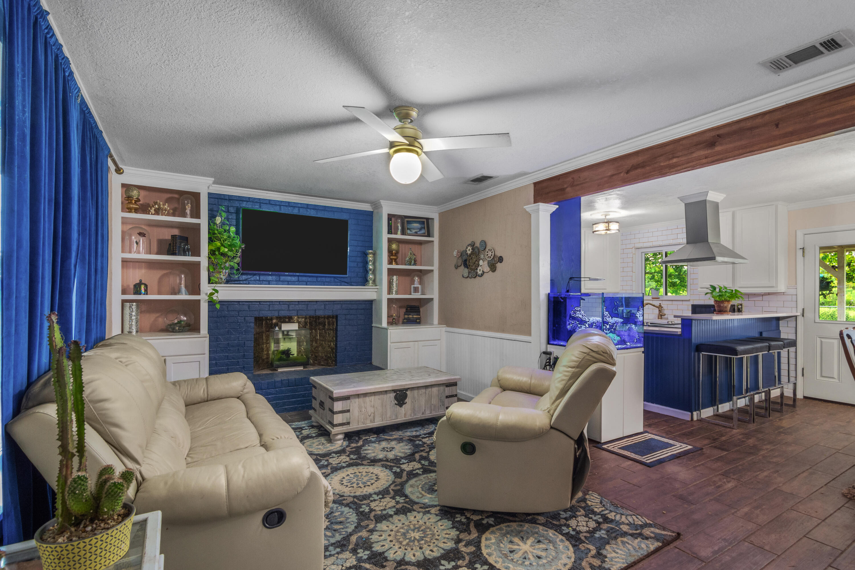 6072 Jack Stokes Road Baker, FL 32531 - Photo 4 of 29 a living room with furniture a fireplace and a flat screen tv