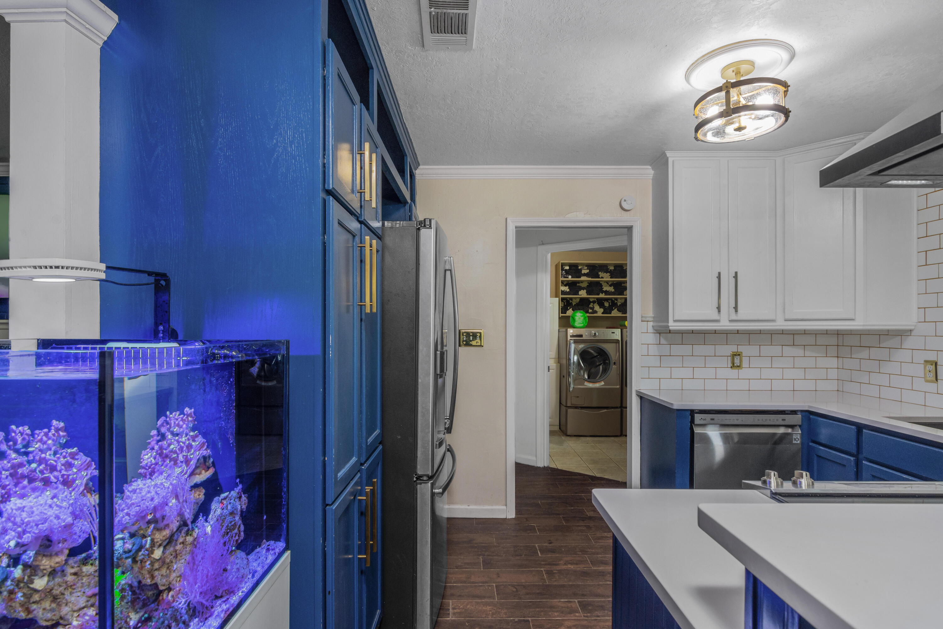 6072 Jack Stokes Road Baker, FL 32531 - Photo 8 of 29 a kitchen with stainless steel appliances granite countertop a refrigerator and a stove top oven